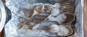 Cupronickel silver spoons and forks with baking soda in foil